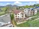 Aerial view of a home featuring a deck with a hot tub and beautiful mountain scenery at 415 Butte Pkwy, Golden, CO 80403