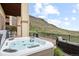 Relaxing outdoor hot tub with stunning mountain views and comfortable patio furniture at 415 Butte Pkwy, Golden, CO 80403