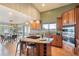 Well-lit kitchen boasts wood cabinets, modern lighting, and adjacent dining area at 415 Butte Pkwy, Golden, CO 80403