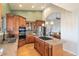 Spacious kitchen features wooden cabinets, granite counters, and views to living space at 415 Butte Pkwy, Golden, CO 80403