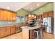 Open kitchen boasts granite countertops, stainless steel appliances, and a center island at 415 Butte Pkwy, Golden, CO 80403