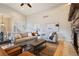Comfortable living room with a stone fireplace, staircase, and large windows, filled with natural light at 415 Butte Pkwy, Golden, CO 80403