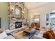 Inviting living room with a stone fireplace and an open layout, seamlessly flowing into the kitchen at 415 Butte Pkwy, Golden, CO 80403
