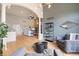 Open living area with vaulted ceilings, a stone fireplace, and modern decor, bathed in natural light at 415 Butte Pkwy, Golden, CO 80403