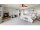 Spacious main bedroom featuring a stone fireplace, ceiling fan, and neutral decor at 415 Butte Pkwy, Golden, CO 80403