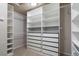 Well-organized walk-in closet with built-in shelving and drawers for optimal storage at 415 Butte Pkwy, Golden, CO 80403