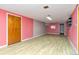 Unfinished basement featuring pink walls and flooring ready for remodeling at 3515 Grape St, Denver, CO 80207