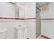 Retro bathroom with white tiles, red accents, sink and shower at 3515 Grape St, Denver, CO 80207