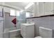 Bathroom with tub/shower, modern vanity, and decorative tile at 3515 Grape St, Denver, CO 80207