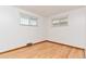 Clean bedroom with hardwood floors, neutral walls and natural light at 3515 Grape St, Denver, CO 80207