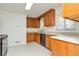 Functional kitchen with wood cabinetry, white countertops, and white tiled floor at 3515 Grape St, Denver, CO 80207