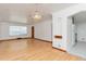 Spacious living room with hardwood floors, archways, chandelier, and white walls at 3515 Grape St, Denver, CO 80207