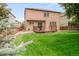 Backyard featuring a well-manicured lawn and deck at 10591 Hyacinth St, Highlands Ranch, CO 80129