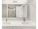 Bright bathroom featuring a double vanity, framed mirror, and brushed nickel faucet at 10591 Hyacinth St, Highlands Ranch, CO 80129