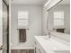 Bright bathroom featuring a double vanity, framed mirror, and brushed nickel faucet at 10591 Hyacinth St, Highlands Ranch, CO 80129