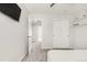 Bedroom with gray carpet, TV, closet, and access to the hall at 10591 Hyacinth St, Highlands Ranch, CO 80129