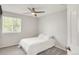Neutral bedroom featuring a ceiling fan, window, and soft carpeting at 10591 Hyacinth St, Highlands Ranch, CO 80129