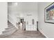 Open foyer showcases staircase, decor shelving, and views into the dining and living areas at 10591 Hyacinth St, Highlands Ranch, CO 80129