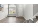 Bright foyer features wood flooring, a large window, and a staircase to the upper level at 10591 Hyacinth St, Highlands Ranch, CO 80129