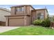 Charming two-story home features a well-maintained lawn and an attached two-car garage at 10591 Hyacinth St, Highlands Ranch, CO 80129