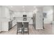 Modern kitchen with white cabinets, stainless steel appliances, and a center island with seating at 10591 Hyacinth St, Highlands Ranch, CO 80129