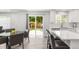 Bright kitchen with white cabinets, stainless steel appliances, and a view of the backyard at 10591 Hyacinth St, Highlands Ranch, CO 80129