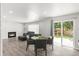 Inviting living room with fireplace, wood floors, and a sliding glass door to the backyard at 10591 Hyacinth St, Highlands Ranch, CO 80129