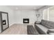 Bright living room with fireplace, wood floors, and a comfortable seating area at 10591 Hyacinth St, Highlands Ranch, CO 80129