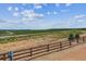 Scenic view of rolling hills from backyard with wooden fence and blue sky at 8672 Pennycress Dr, Littleton, CO 80125