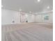 Large basement area featuring neutral carpeting, recessed lighting, and a doorway leading to additional space at 8672 Pennycress Dr, Littleton, CO 80125