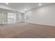 Large basement area featuring neutral carpeting, recessed lighting, and a doorway to the wet bar at 8672 Pennycress Dr, Littleton, CO 80125