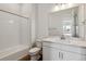 Bright bathroom with white cabinets, white subway tile shower, and modern fixtures at 8672 Pennycress Dr, Littleton, CO 80125