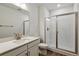 Modern bathroom featuring sleek vanity, glass-enclosed shower, and modern fixtures at 8672 Pennycress Dr, Littleton, CO 80125