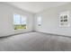 Bright bedroom featuring large windows and neutral carpeting, offering scenic views and a serene atmosphere at 8672 Pennycress Dr, Littleton, CO 80125