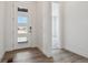 Bright entryway with a modern front door, wood-look flooring and an open view into other rooms at 8672 Pennycress Dr, Littleton, CO 80125