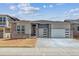 Charming single Gathering home with an attached two car garage and stone accents on the facade at 8672 Pennycress Dr, Littleton, CO 80125