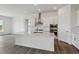 Modern open-concept kitchen with white cabinets, stainless steel appliances and a large island at 8672 Pennycress Dr, Littleton, CO 80125