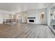 Bright and spacious living room with a modern fireplace, lots of windows and wood-look floors at 8672 Pennycress Dr, Littleton, CO 80125