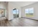 Bright living room featuring modern wood-look floors and large sliding doors with beautiful outdoor views at 8672 Pennycress Dr, Littleton, CO 80125