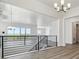 Open living space with hardwood floors, a modern chandelier, and scenic views from large windows at 8672 Pennycress Dr, Littleton, CO 80125