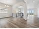 Open concept living space with hardwood floors, black metal railings, and large windows at 8672 Pennycress Dr, Littleton, CO 80125