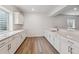 Basement wet bar featuring white cabinetry, quartz countertops, and modern fixtures, ideal for entertaining at 8672 Pennycress Dr, Littleton, CO 80125
