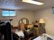 View of basement bedroom with small window, dresser, and cluttered furnishings at 3910 E Orchard Rd, Centennial, CO 80121