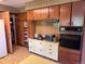 Kitchen featuring wood cabinets, retro countertops, and appliances at 3910 E Orchard Rd, Centennial, CO 80121