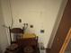 Laundry hook-ups against white wall next to two chairs at 3910 E Orchard Rd, Centennial, CO 80121