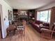 Cozy living room featuring a brick fireplace, built-in bookshelves, and hardwood floors at 3910 E Orchard Rd, Centennial, CO 80121
