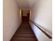 Carpeted staircase to basement with handrail and white walls at 3910 E Orchard Rd, Centennial, CO 80121
