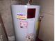 Close up of a water heater with plumber advertising on the front at 3910 E Orchard Rd, Centennial, CO 80121