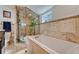 Bathroom featuring a tub, shower with glass door, and modern fixtures at 2215 Meade St, Denver, CO 80211