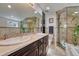 Elegant bathroom featuring dual sinks, a large mirror, a glass-enclosed shower, and luxurious finishes at 2215 Meade St, Denver, CO 80211